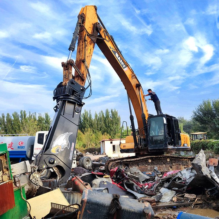 hydraulic scrap shear working in scrap metal recycling yard