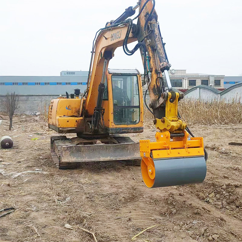 excavator compaction wheel attachment mounted on crawler excavator in field test