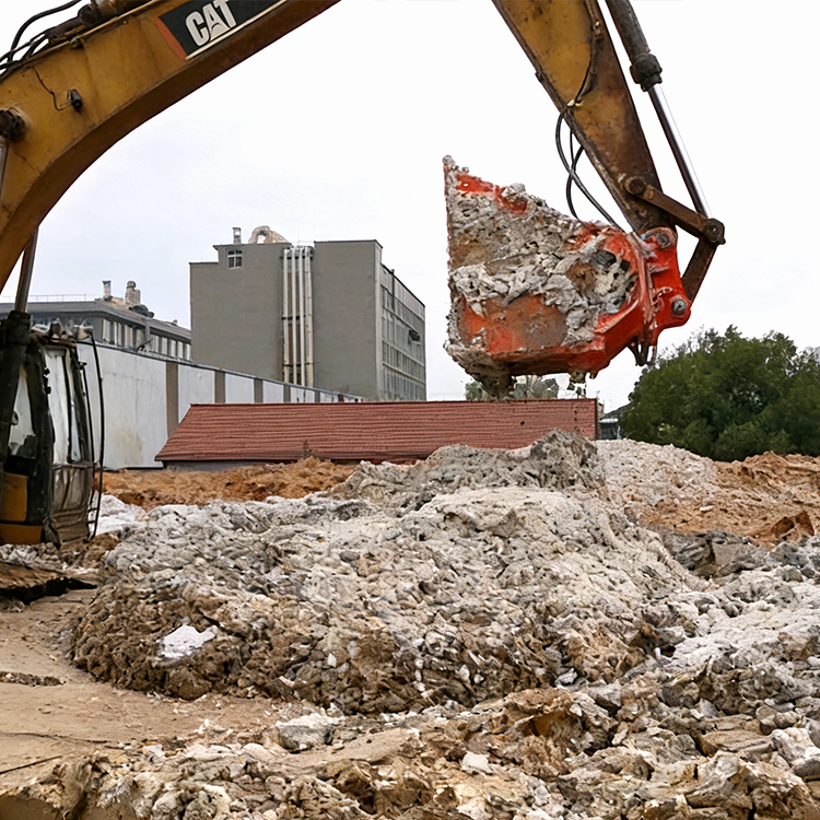 screening bucket in use for demolition debris and concrete material