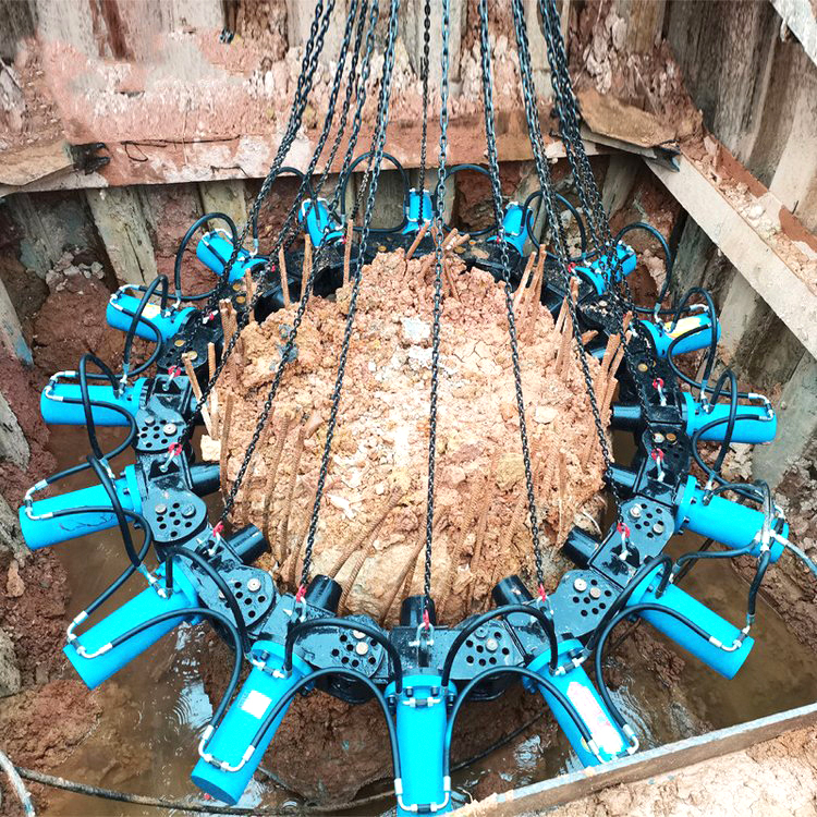 hydraulic pile breaker removing concrete pile head in deep foundation pit