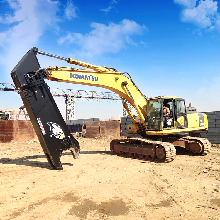 mobile shear mounted on excavator at open demolition site