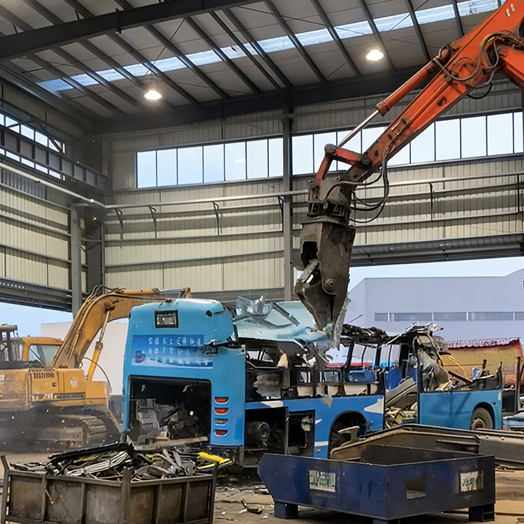 Vehicle dismantling shear lifting bus body during scrap vehicle recycling