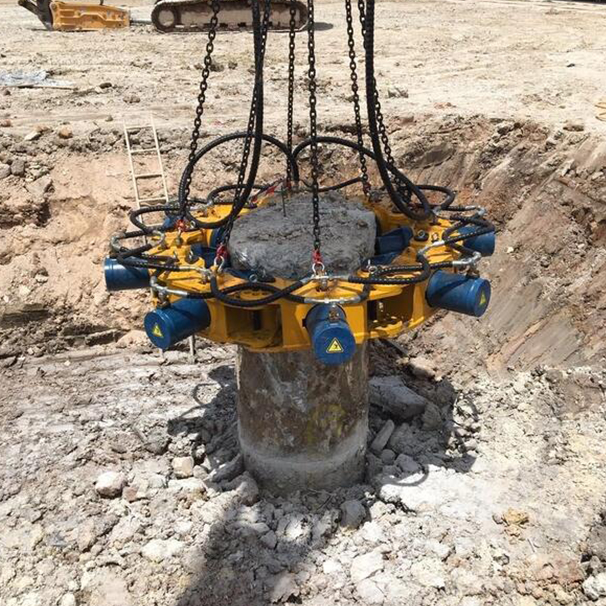 pile cutter removing concrete pile head on dry construction site
