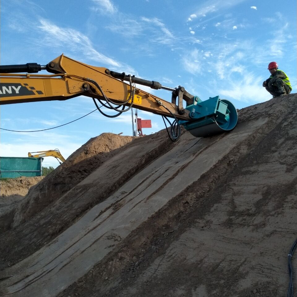 excavator compaction roller attachment compacting steep soil slope