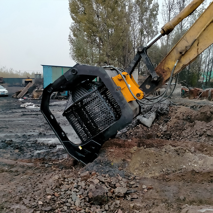 Trommel bucket discharging screened soil fines