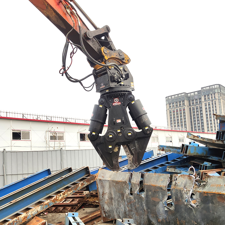 close-up hydraulic shear gripping torn steel plate at demolition site