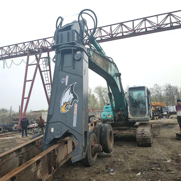 excavator shear attachment upright on jobsite during setup