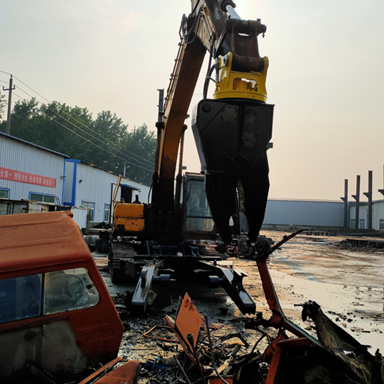 Auto dismantling shear working on scrap vehicle parts in a scrapyard