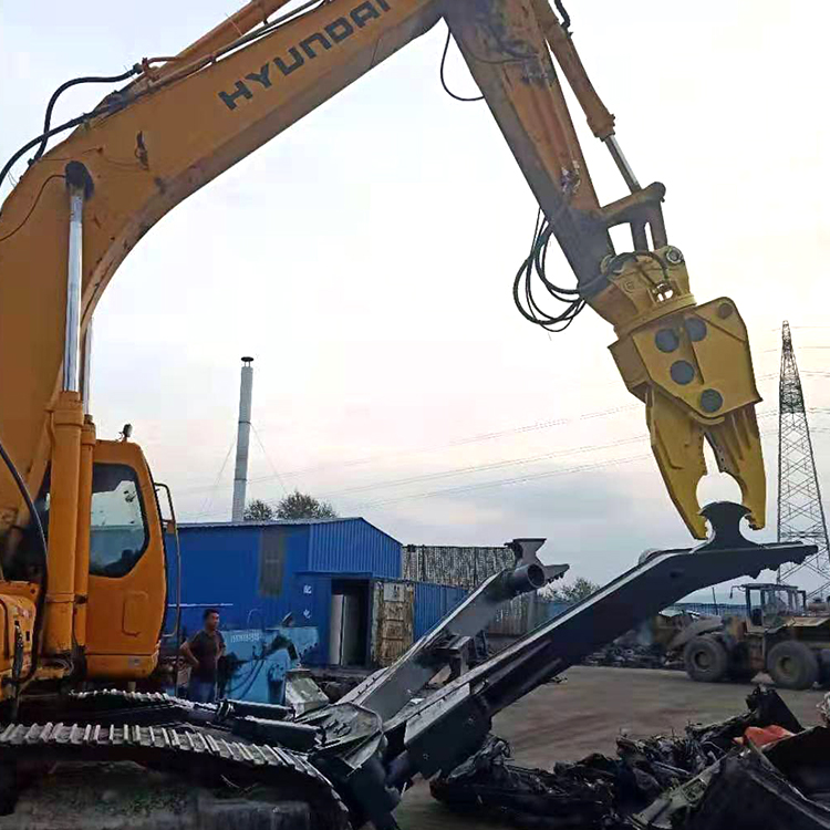 Scrap vehicle dismantling shear separating steel parts with a Hyundai excavator