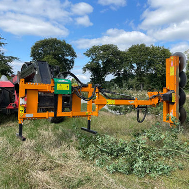Disc Hedge Trimmer on tractor arm cutting roadside vegetation