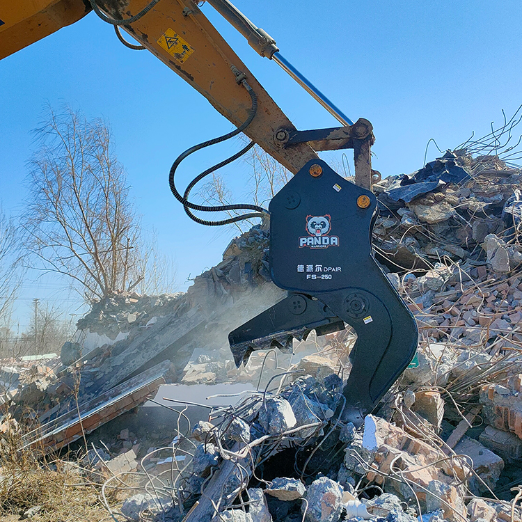 hydraulic pulverizer working on demolition rubble pile