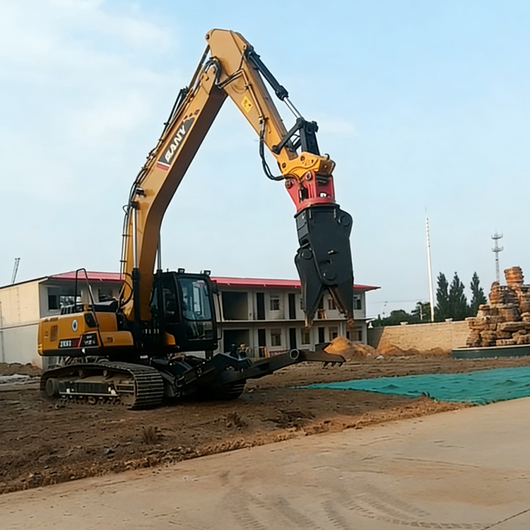 Car dismantling shear attachment mounted on excavator at a worksite