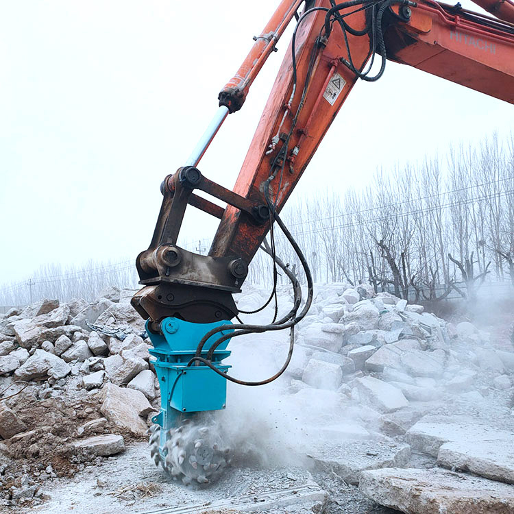 rock grinder attachment working on rock excavation with dust