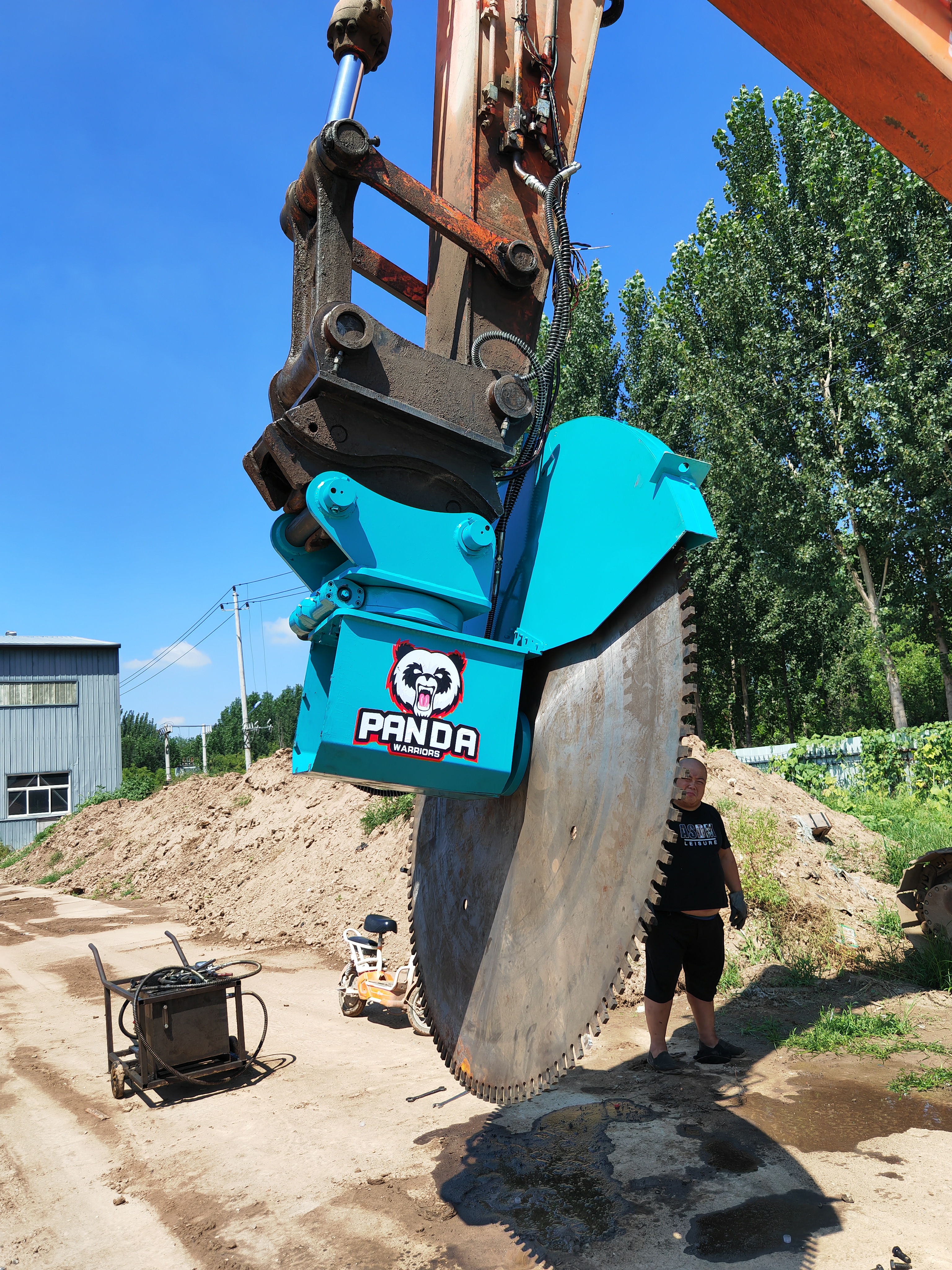 excavator rock cutter suspended from excavator for inspection