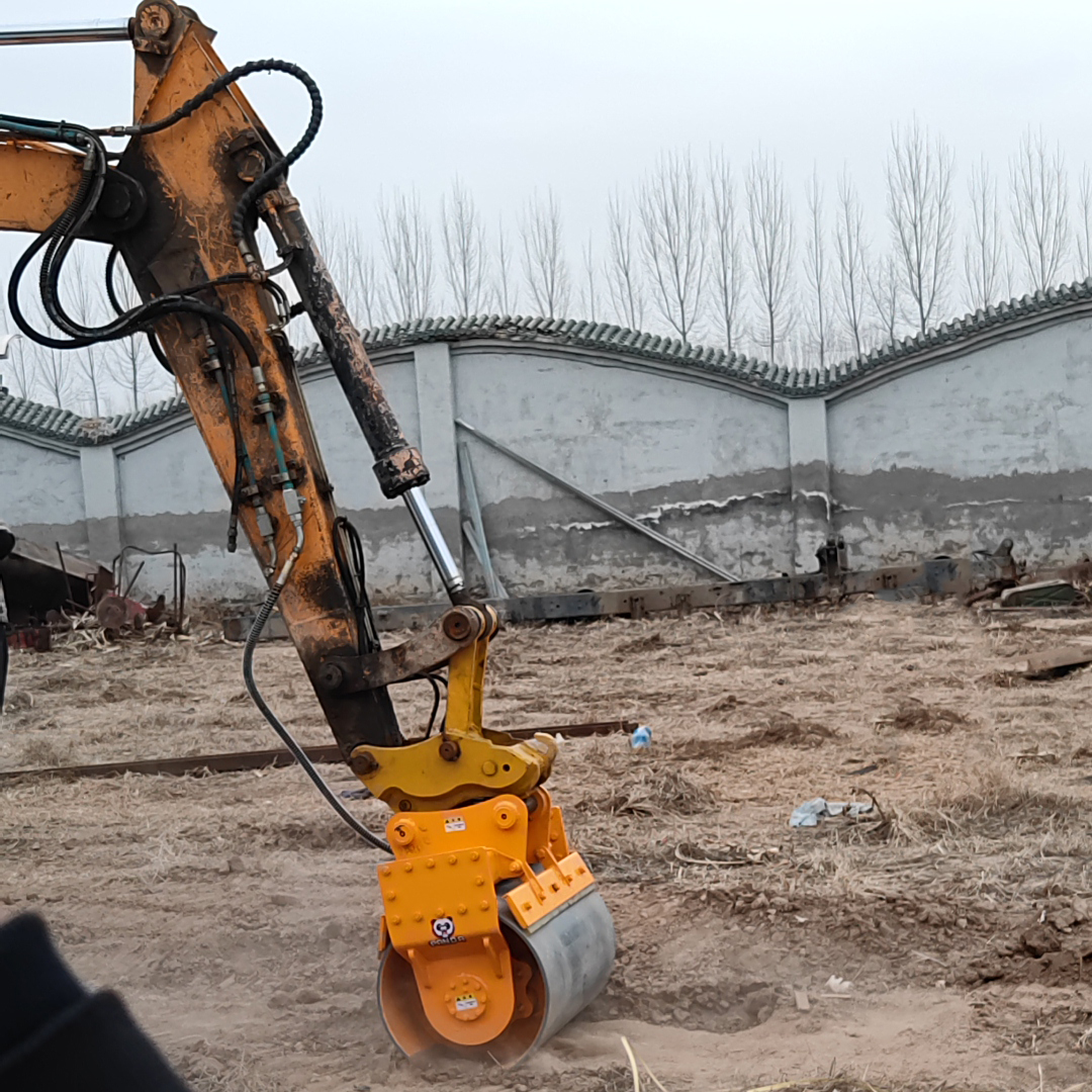 excavator compaction wheel compacting loose soil in live demonstration