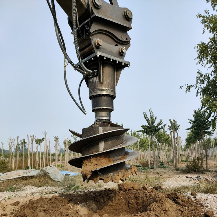 excavator earth auger drilling hole in compact soil