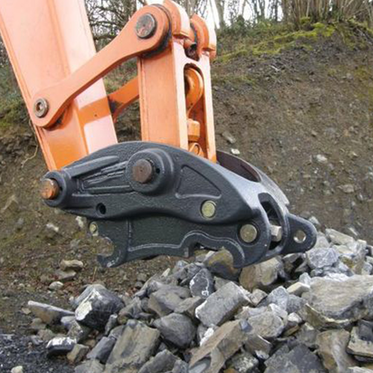 pin grabber coupler installed on excavator at rock site