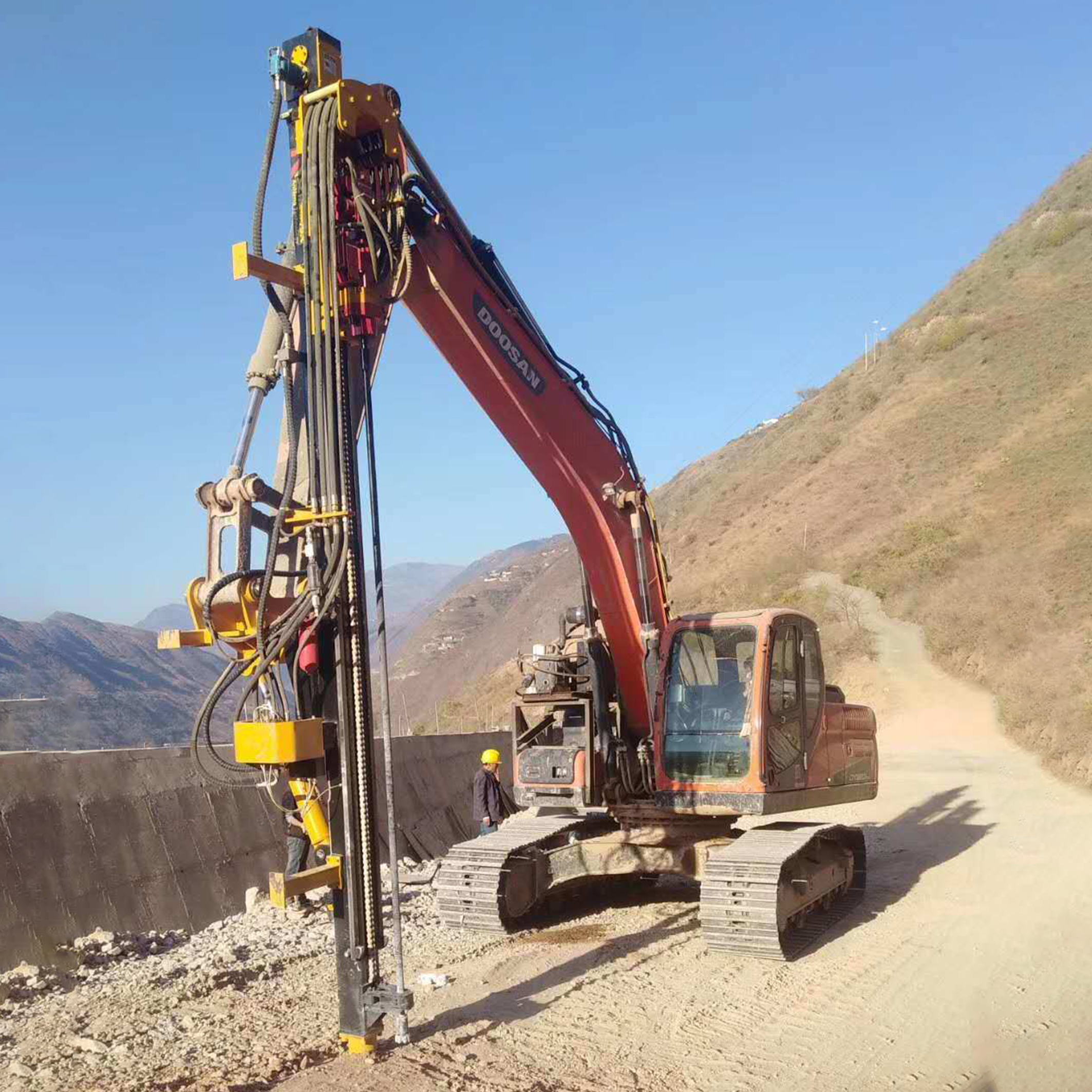 Excavator Mounted Rock Drill working on mountain road slope drilling