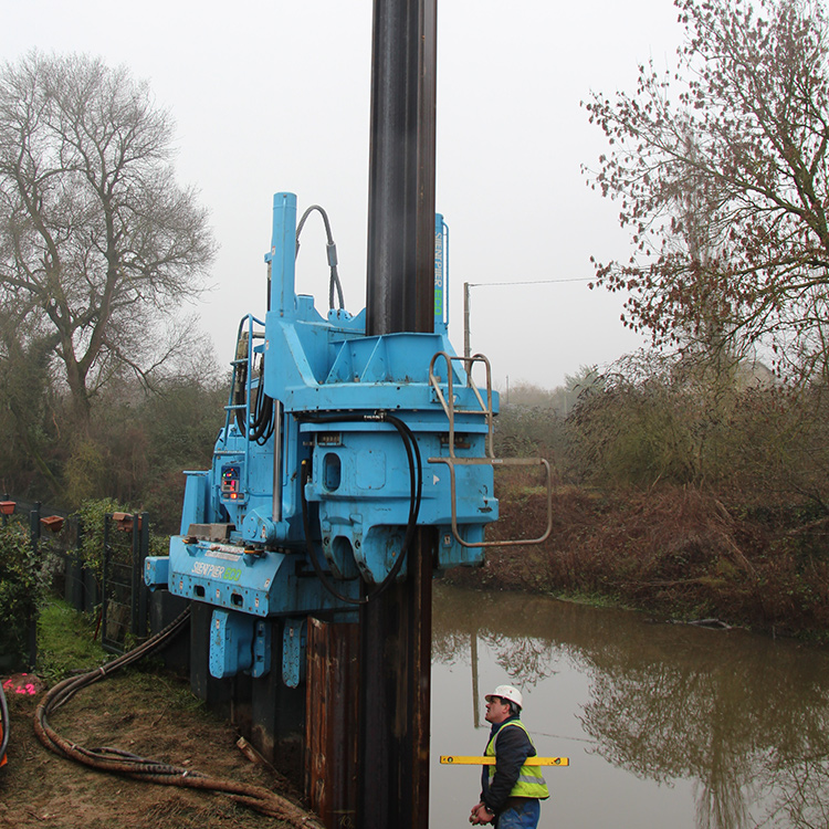 Hydraulic Static Pile Driver installing sheet piles beside river project