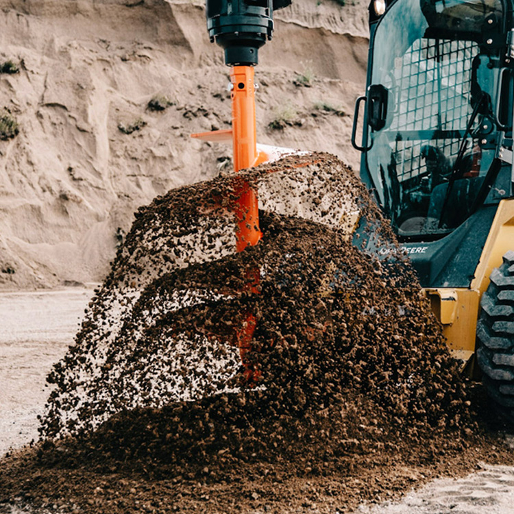 auger throwing soil during ground drilling