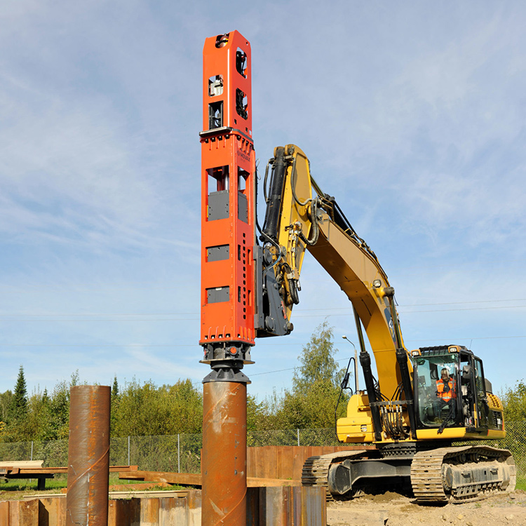 Hydraulic impact hammer driving steel pile on construction site