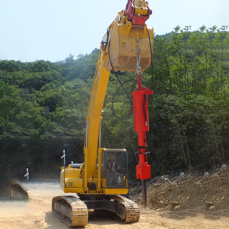 Excavator rock splitter working on outdoor construction site