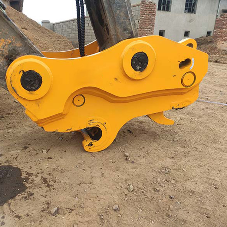 yellow quick attach coupler mounted on excavator