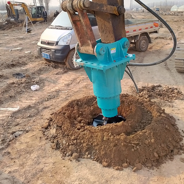 excavator auger drive drilling hole on jobsite