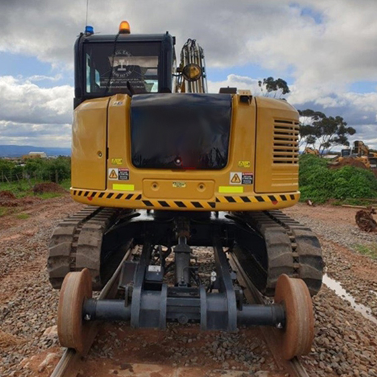On-track excavator rear view on railway line