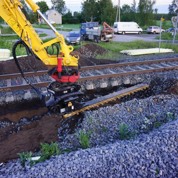 railway ballast cleaner working beside track