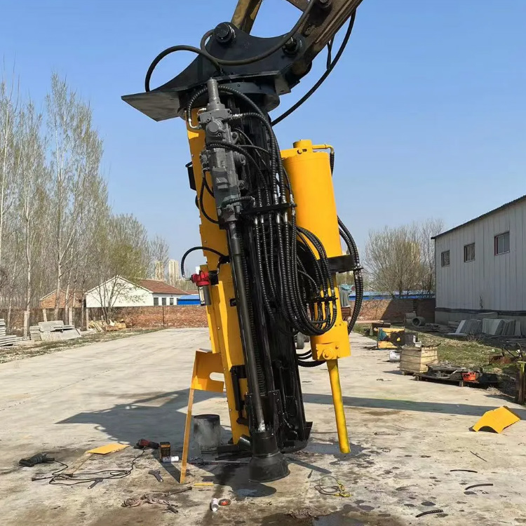 excavator-mounted drilling and splitting machine in equipment yard