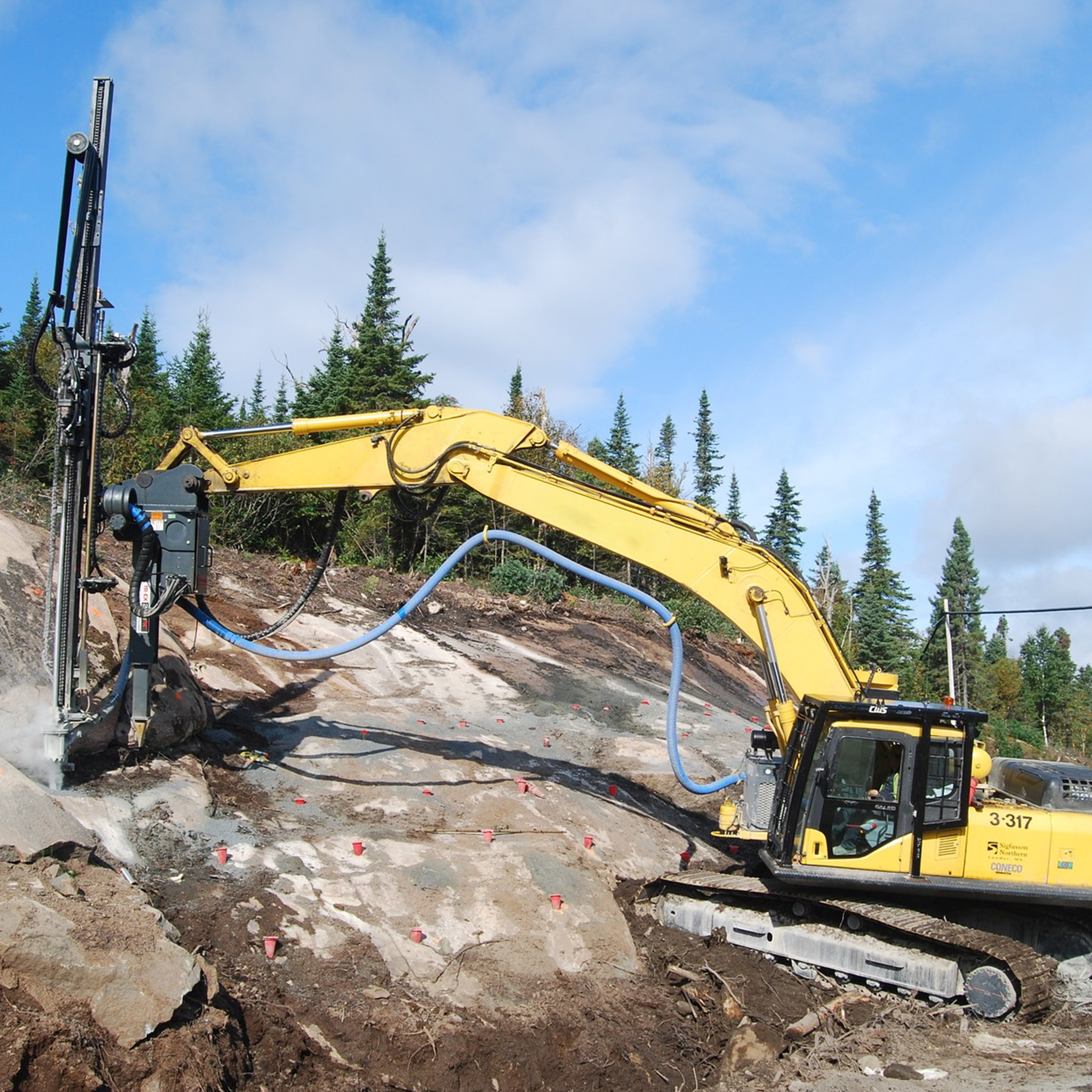 Excavator Rock Drilling Attachment drilling on rocky slope