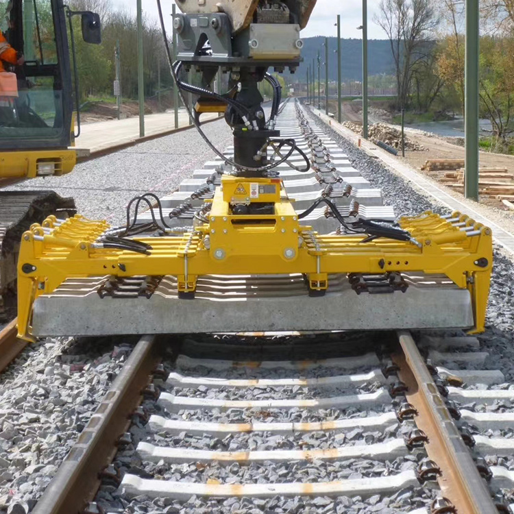 Sleeper Laying Machine positioning a concrete sleeper on rails
