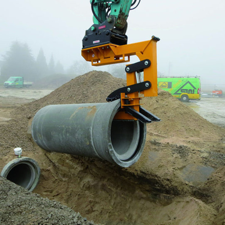 Pipe Handling Attachment lifting a concrete pipe for trench placement