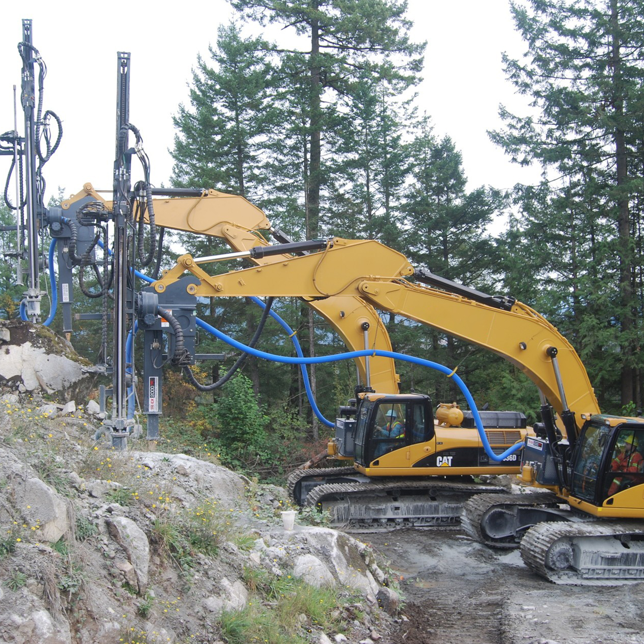 Surface Drill Rig with excavator carriers on rocky hillside