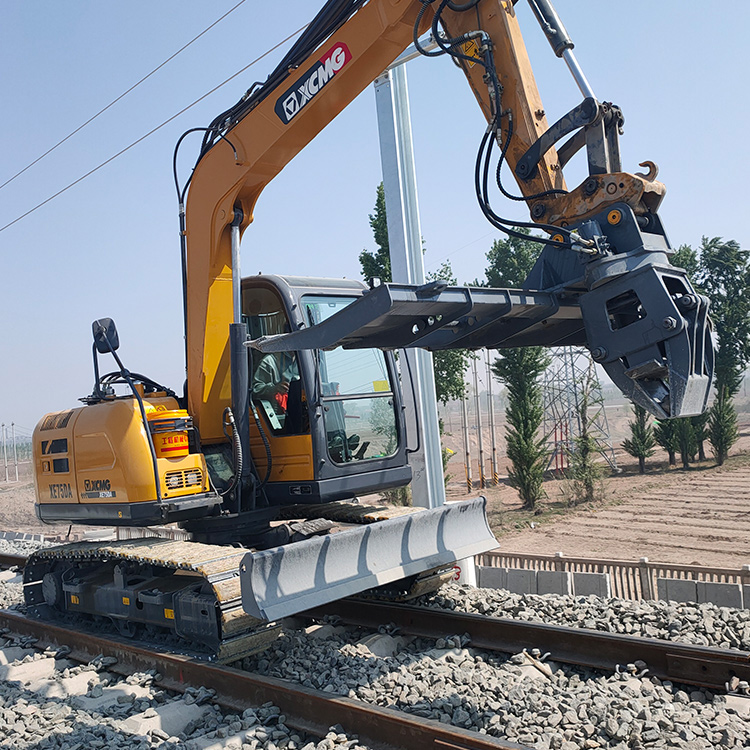 Tie Exchanger attachment on excavator above rail track