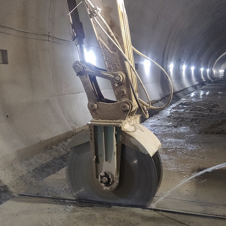 excavator mounted rock saw working inside tunnel