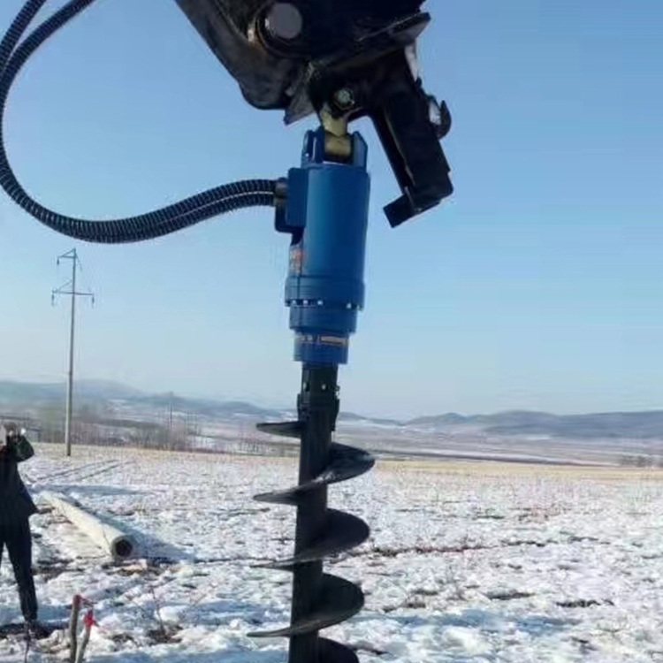 Hydraulic Earth Drill working outdoors in winter ground drilling conditions