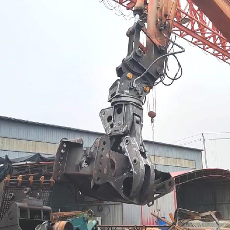 hydraulic rotating scrap grapple hanging in industrial yard