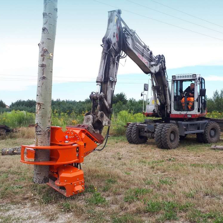 Excavator tree saw gripping a standing tree trunk in field work