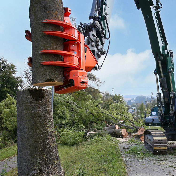 Tree saw with grapple holding a cut tree trunk section