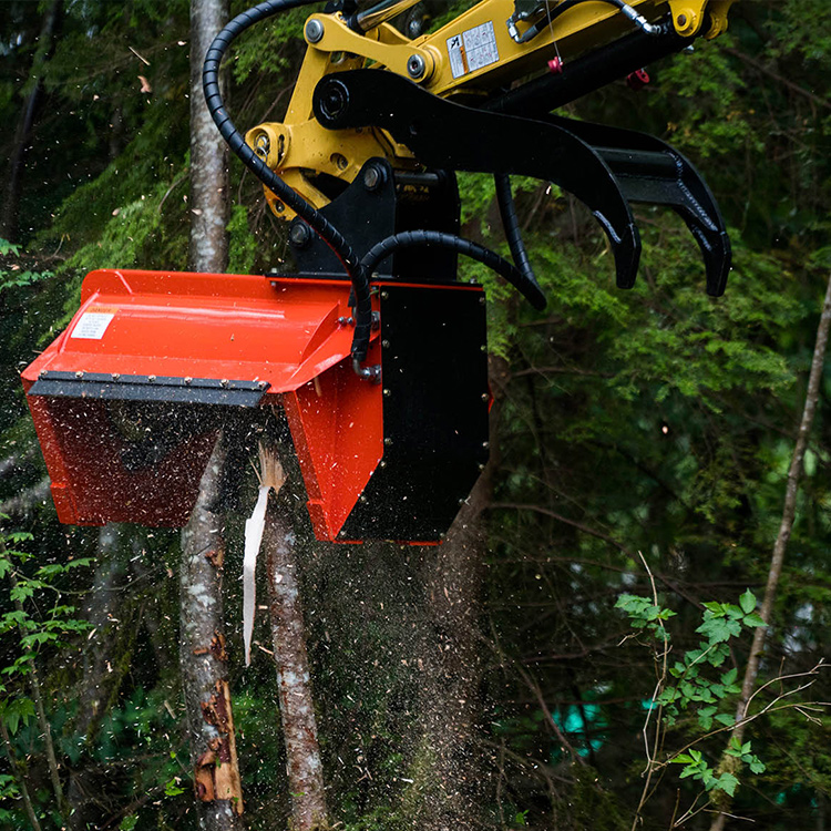 Excavator mulching head cutting brush and woody vegetation in close-up action