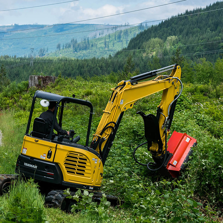 Excavator mower head clearing slope vegetation with mini excavator
