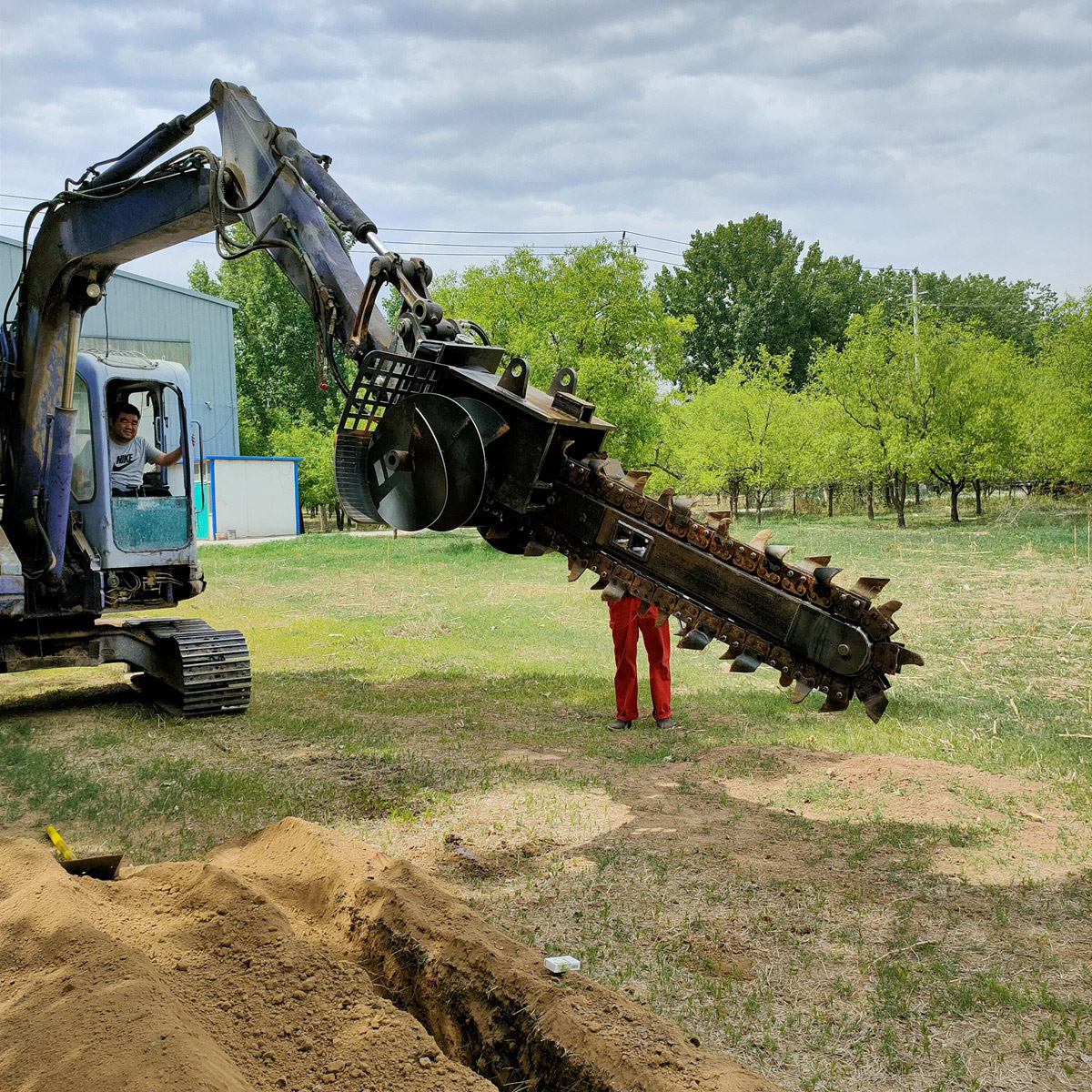 chain trencher mounted on excavator boom field demo
