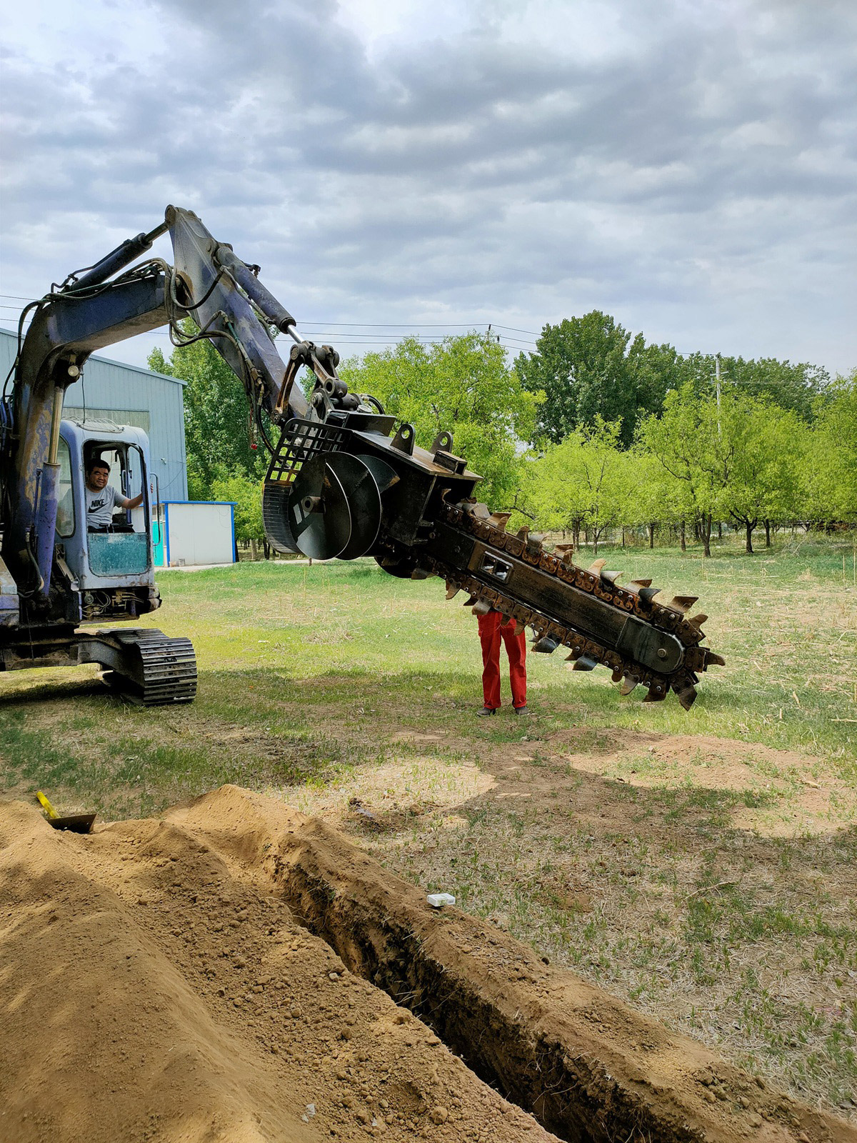 chain trencher mounted on excavator boom field demo